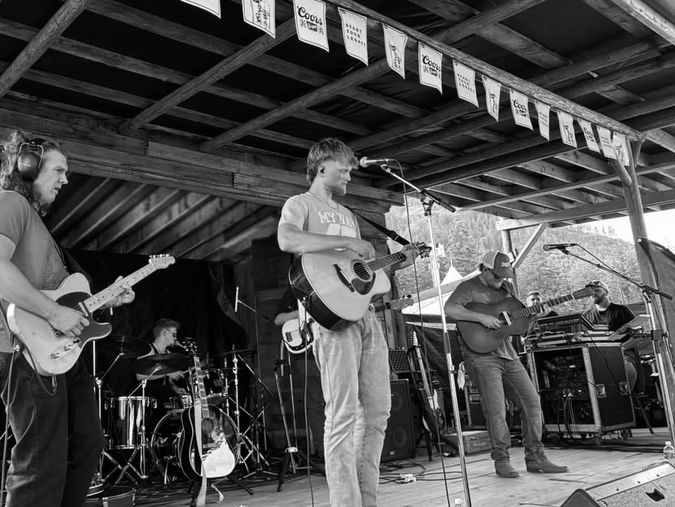 Seb Lind playing live with his band on an outdoor stage